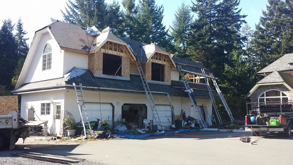 Re-roof in progress of a two story garage
